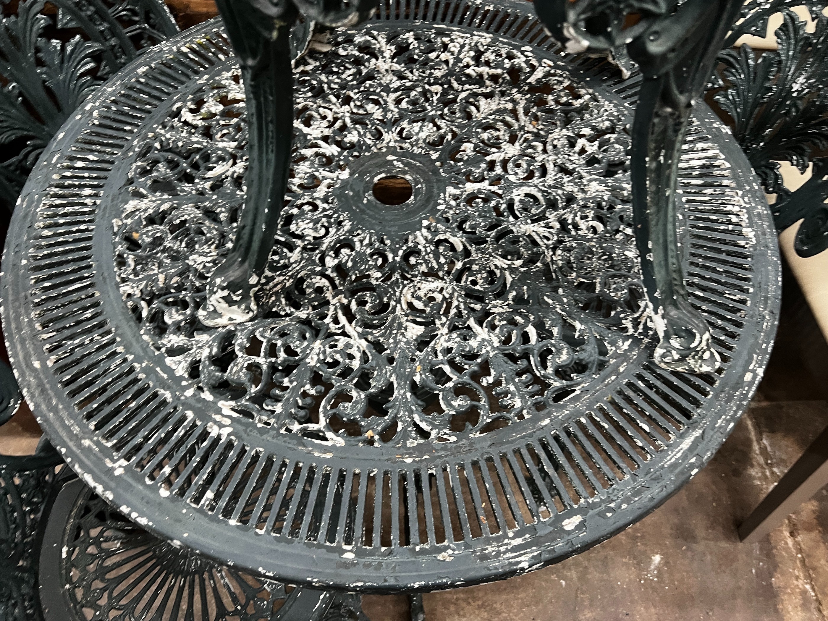 A Victorian style circular aluminium garden table and four chairs, table diameter 80cm height 69cm